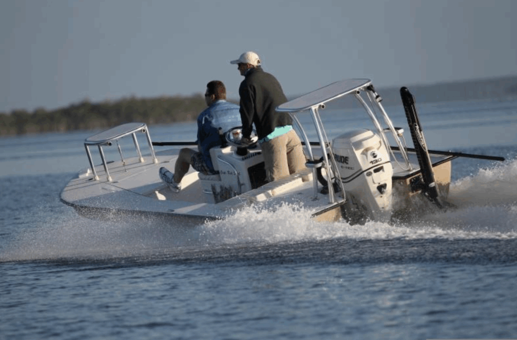 Two fishermen on a flats fishing boat navigating the waters of the Florida Keys, showcasing inshore fishing adventures.
