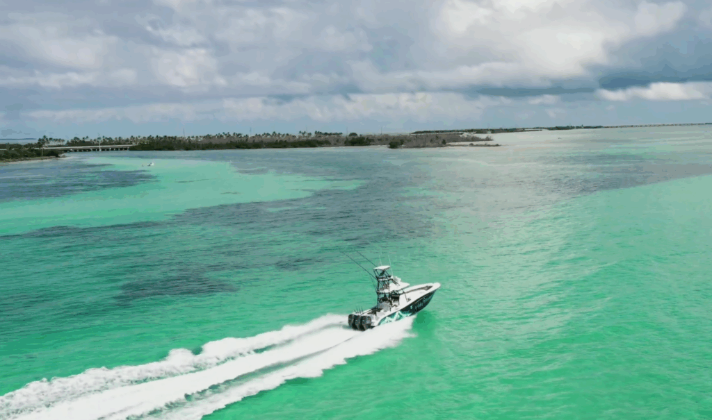 Fishing charter boat navigating vibrant turquoise waters in the Florida Keys, showcasing a scenic view ideal for inshore and offshore fishing adventures.